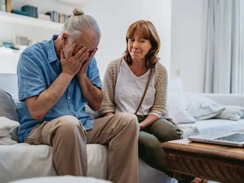 couples-counseling-harder-before-easier Couple having a hard conversation in their living room at home.