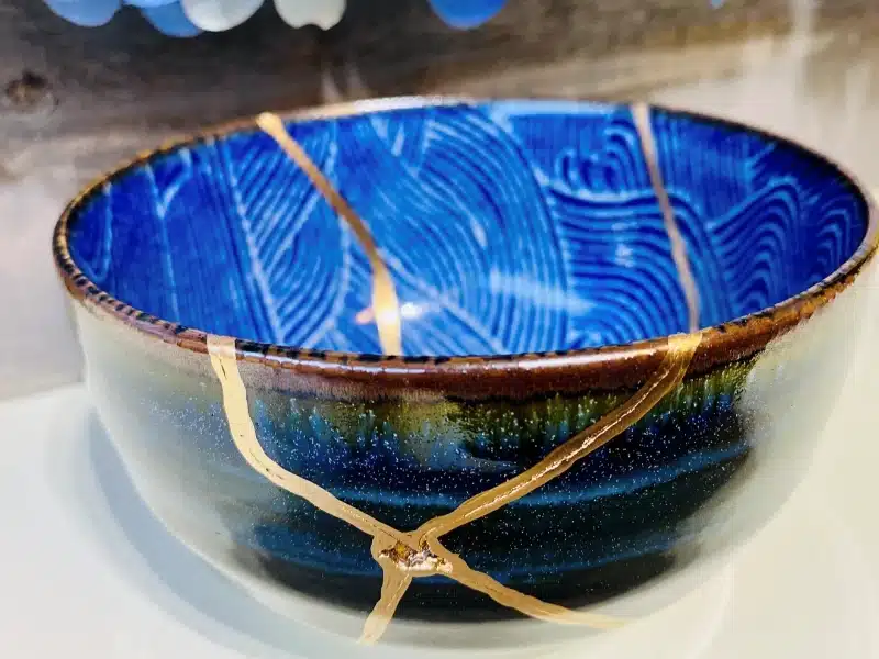 glazed blue and gold clay bowl.
